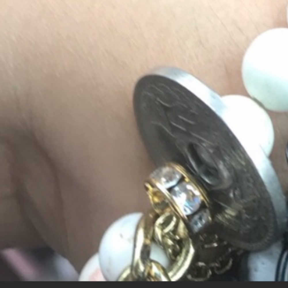 One white beaded bracelet with French Coin.